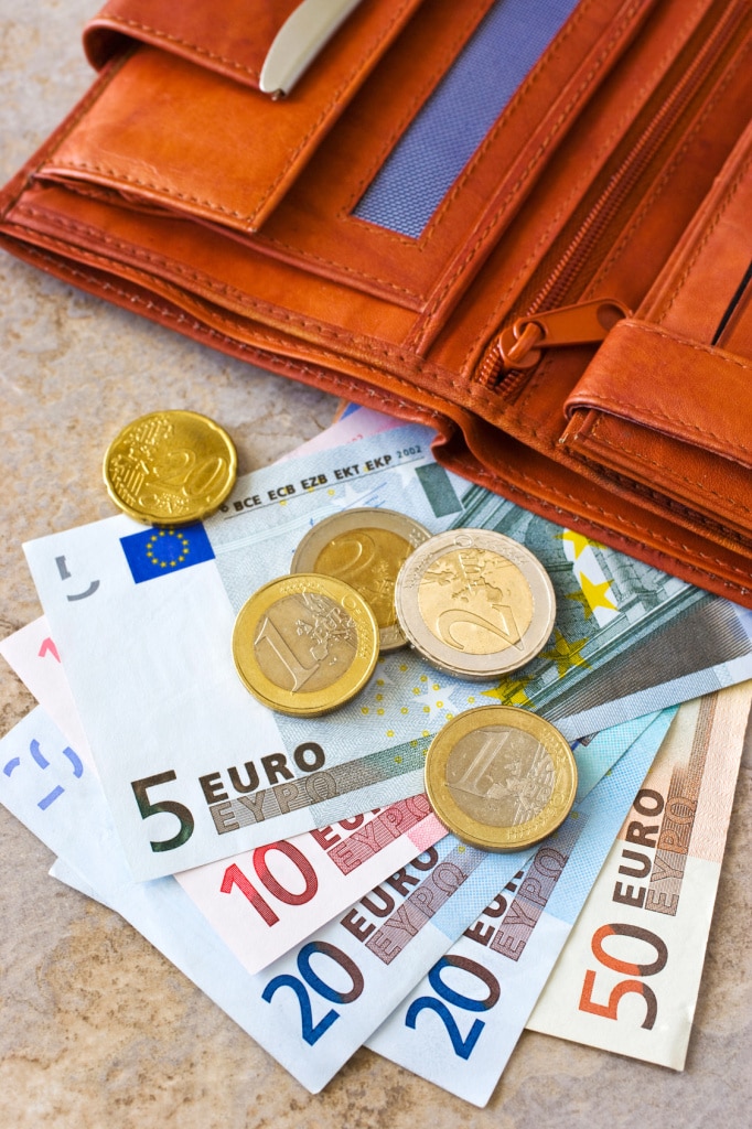 Euro money - banknotes and coins - in brown wallet